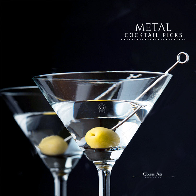 Metal cocktail picks with olive garnish